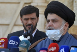 Iraqi cleric Muqtada Al-Sadr delivers a statement on Feb. 10, 2021 in which he backed early elections overseen by the UN. (Photo via Getty Images)