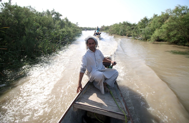 A man on a boat ride in the Iraqi Marshlands. July 14, 2016 Maysan governorate, Southern Iraq (Photo via Getty Images)