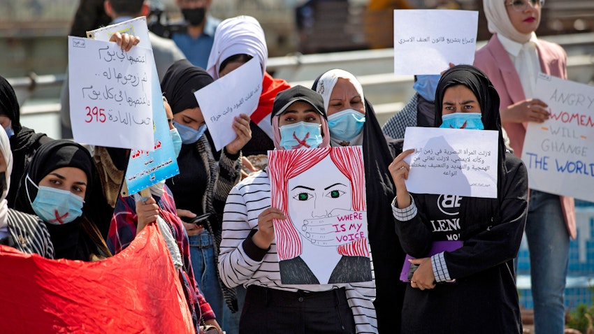 Demonstrators wearing crossed-out masks attend a rally for International Women's Day in Iraq's southern city of Basra on March 8, 2021. (Photo via Getty Images)