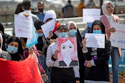 Demonstrators wearing crossed-out masks attend a rally for International Women's Day in Iraq's southern city of Basra on March 8, 2021. (Photo via Getty Images)