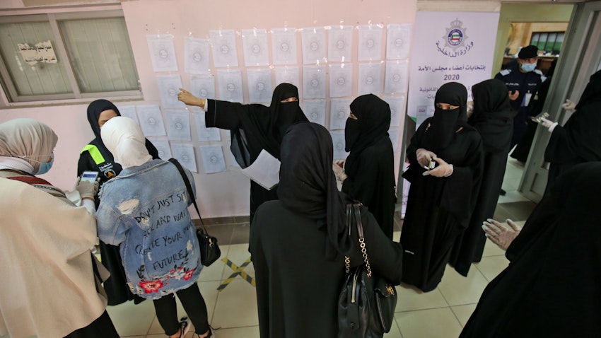 Women arrive to cast their votes at a polling station in Kuwait City, on Dec. 5, 2020 (Photo via Getty Images)