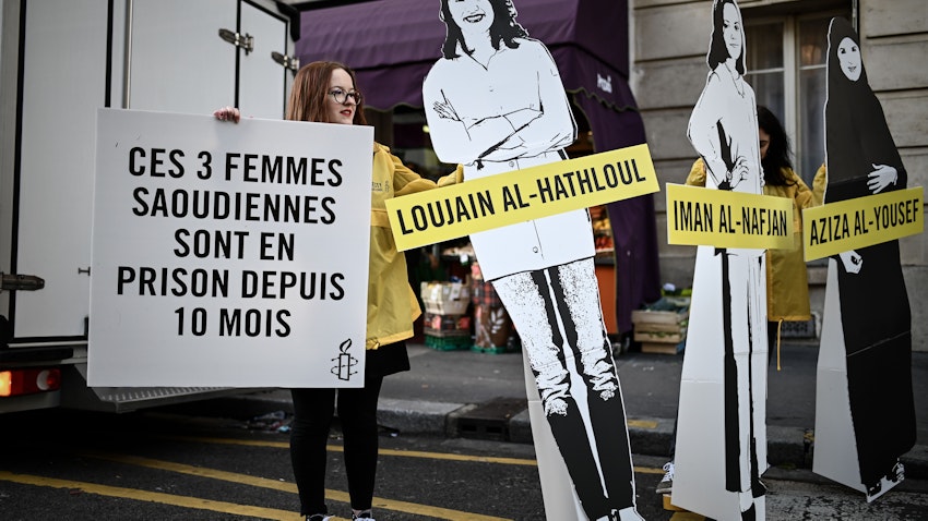 Cartoon cutouts of women incarcerated in Saudi Arabia, outside the Saudi embassy in Paris, France on March 8, 2019 (Photo via Getty Images)