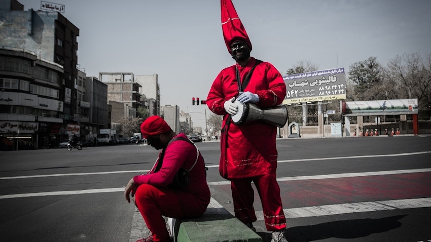 Two men wearing Haji Firouz costumes in a street in Iran's capital city Tehran. March 17, 2020. (Photo by Zohreh Salimi via ANA News Agency)