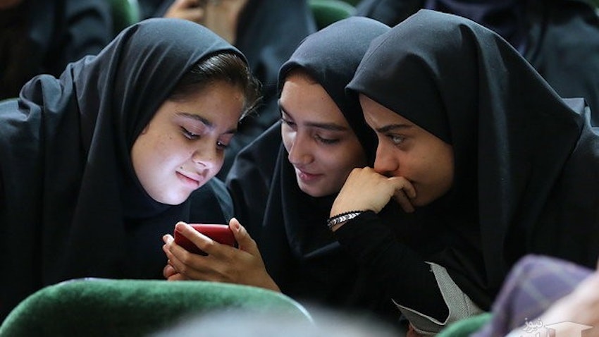 Three young Iranian girls looking at a smartphone's LCD screen. Alborz, Iran. Aug 4, 2019. (Photo via IRNA News Agency)