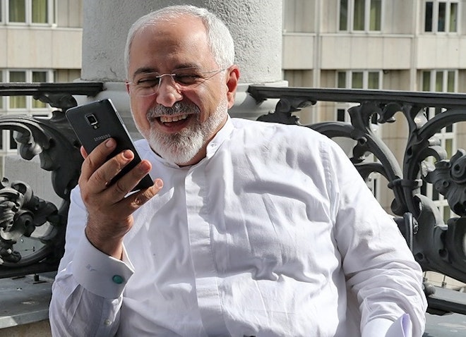 Iran's FM Zarif looking at his cell phone before a nuclear negotiation meeting in Vienna, Austria on July 11, 2015. (Photo by Siamak Ebrahimi via Tasnim News Agency)