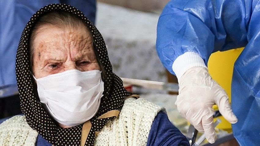An elderly Iranian woman receives a vaccine shot. Urmia, Iran. Mar. 18, 2021. (Photo by Mojtaba Esmail Zad via Tasnim News Agency)