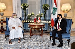 Qatar's Defense Minister Khalid bin Mohammad Al-Attiyah welcomes Lebanon's Prime Minister Hassan Diab in Doha on Apr. 19, 2021 (Photo via Getty Images)