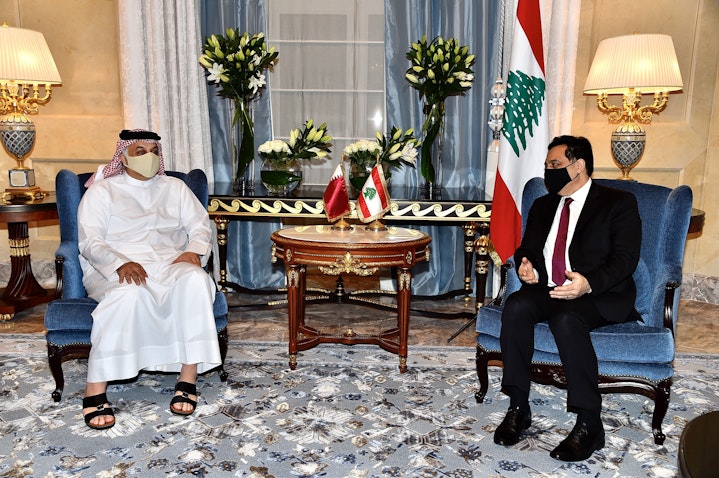Qatar's Defense Minister Khalid bin Mohammad Al-Attiyah welcomes Lebanon's Prime Minister Hassan Diab in Doha on Apr. 19, 2021 (Photo via Getty Images)