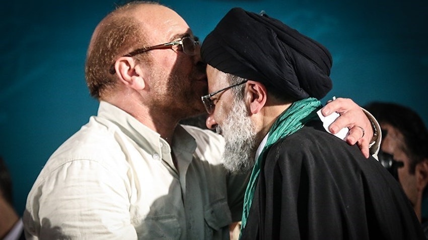 Parliament Speaker Mohammad Baqer Qalibaf kisses Chief Justice Ebrahim Raisi’s forehead at an electoral summit in Tehran, Iran on May 17, 2017. (Photo by Mahmoud Hosseini via Tasnim News Agency)