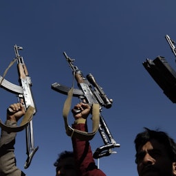 Supporters of the Houthis hold up firearms in Sana'a, Yemen on Jan. 18, 2021. (Photo via Getty Images)