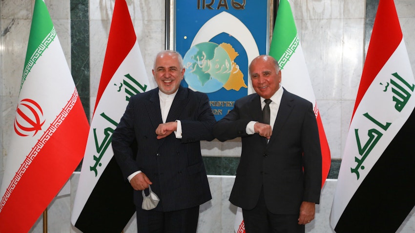 Iranian Foreign Minister Mohammad Javad Zarif (left) greets his Iraqi counterpart Fuad Hussein in Baghdad on April 26, 2021. (Photo via Getty Images)