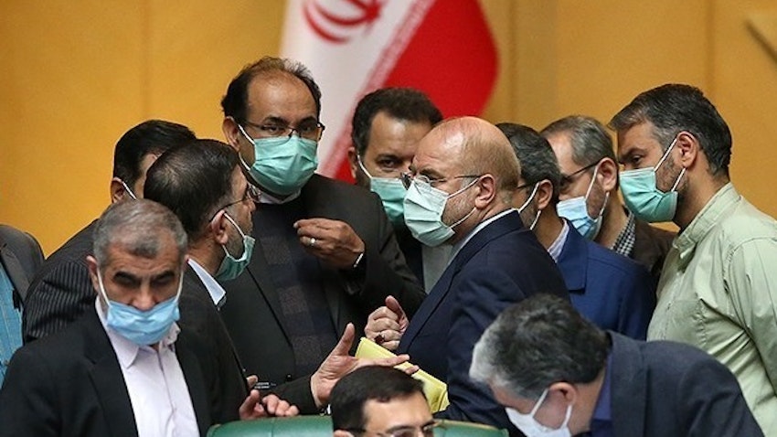 A group of Iranian lawmakers talking to each other in a parliamentary session. Tehran, Iran. March. 16, 2021.  (Photo by Seyyed Mahmoud Hosseini via Tasnim News Agency)