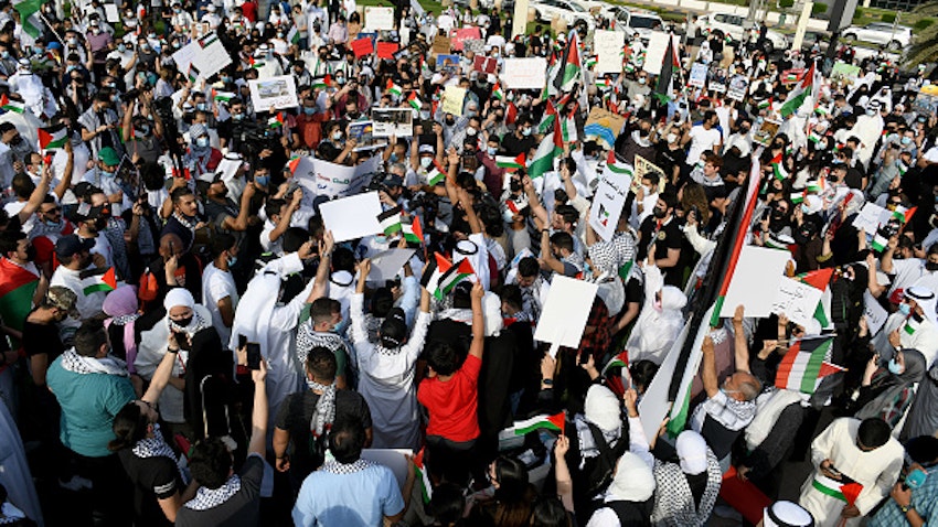 Kuwaitis hold banners and Palestine flags during a demonstration against Israel in Kuwait City on May 11, 2021. (Photo via Getty Images)