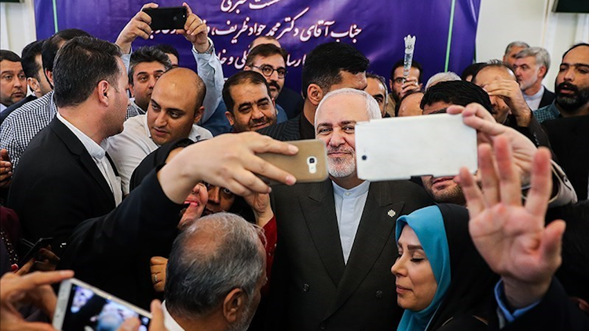 Iran's Foreign Minister Mohammad Javad Zarif poses for selfies with reporters as he leaves a press conference in Tehran on Aug. 5, 2019. (Photo by Hamed Malekpour via Tasnim News Agency)