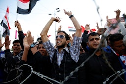 Supporters of Iraqi Shiite cleric Muqtada Al-Sadr chant slogans in Baghdad on March 24, 2017. (Photo via Getty Images)