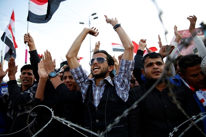 Supporters of Iraqi Shiite cleric Muqtada Al-Sadr chant slogans in Baghdad on March 24, 2017. (Photo via Getty Images)