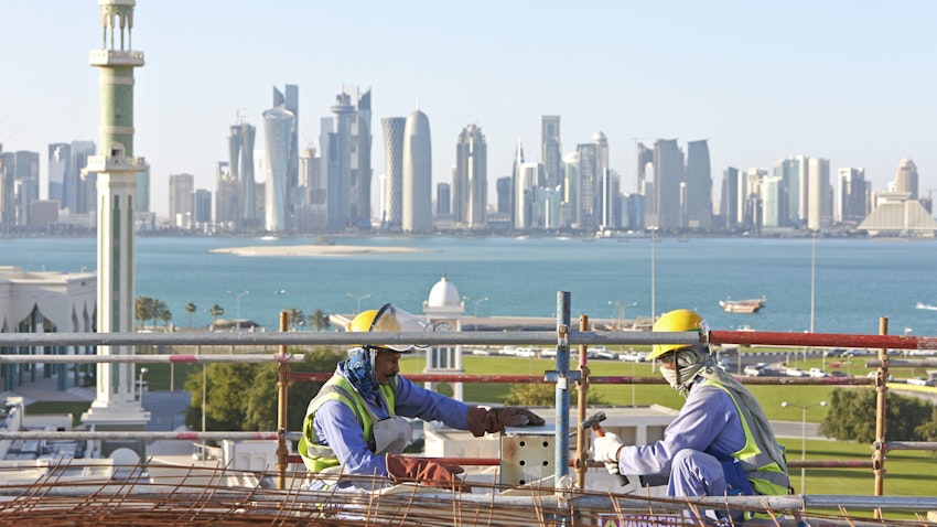 Laborers work on a construction site in Doha, Qatar. March 26, 2013. (Photo via Getty Images)