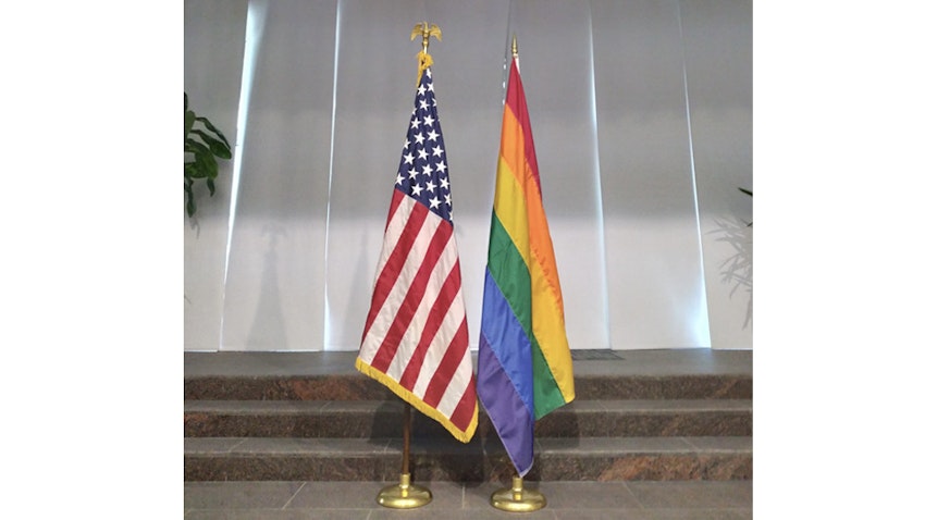 A rainbow flag is put on display alongside the US flag inside the US embassy in Manama, Bahrain on June 2, 2021. (Photo via Twitter/@USEmbassyManama)