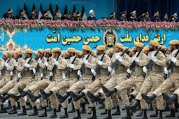 Iranian President Hassan Rouhani (top center) reviews army troops marching during the National Army Day parade in Tehran, Iran on Apr. 18, 2019. (Photo by Hossein Zohrevand via Tasnim News Agency)