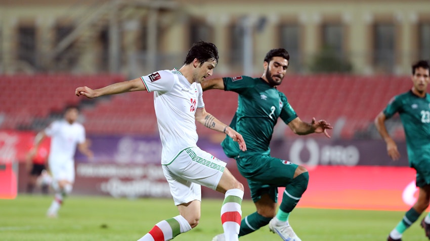 Iran’s Sardar Azmoun in action against Iraq’s Ahmad Ibrahim Khalaf during a FIFA World Cup qualifier in Bahrain on June 15, 2021. (Photo via Getty Images)