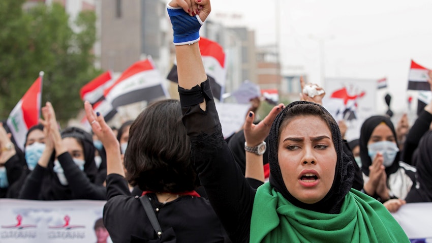 An Iraqi woman raises her fist during anti-government protests in Basra on Dec. 2, 2019. (Photo via Getty Images)