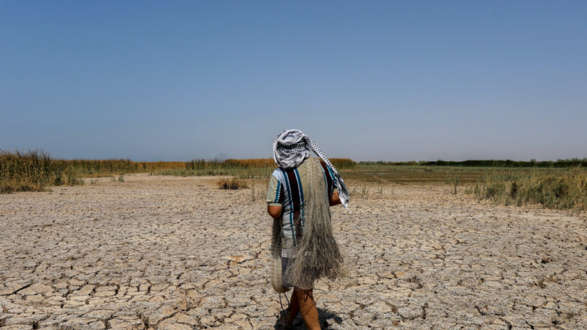 An Iranian fisherman passes the dried up Houralazim lagoon in Khuzestan province on July 4, 2021. (Photo by Amir Abidawi via ISNA News Agency) 