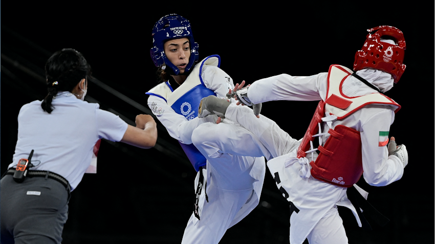 Iranian taekwondoka Nahid Kiani (right) fights Iranian Refugee Team member Kimia Alizadeh (left) in the Tokyo Olympics on July 25, 2021. (Photo via Getty Images)
