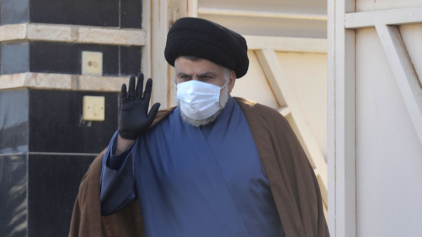 Iraqi cleric and politician Muqtada Al-Sadr in waves outside his home in the holy city Najaf, Iraq on Feb. 10, 2021. (Photo via Getty Images)