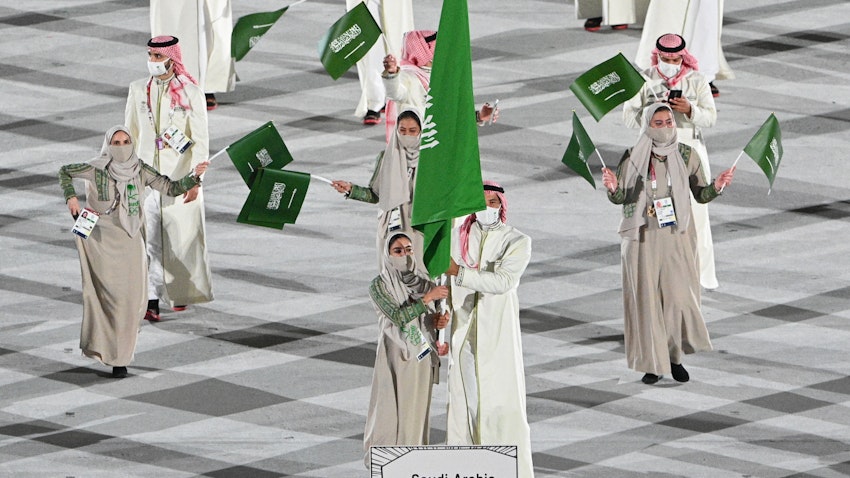 Saudi judoka Tahani Al-Qahtani (L) leads her country’s delegation at the Tokyo Olympics opening ceremony. Jul. 23, 2021. (Photo via Getty Images)