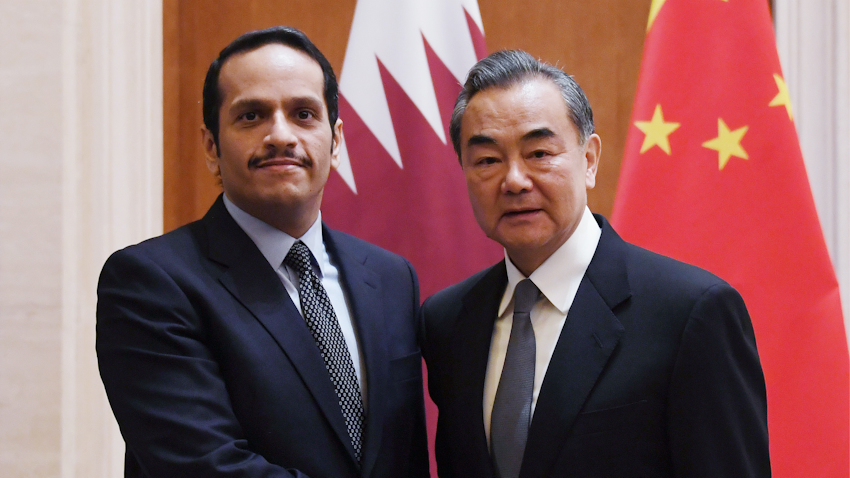 Qatari Deputy Prime Minister and Foreign Minister Sheikh Mohammed bin Abdulrahman Al Thani (L) is greeted by his Chinese counterpart Wang Yi in Beijing on Dec. 12, 2018. (Photo via Getty Images). 