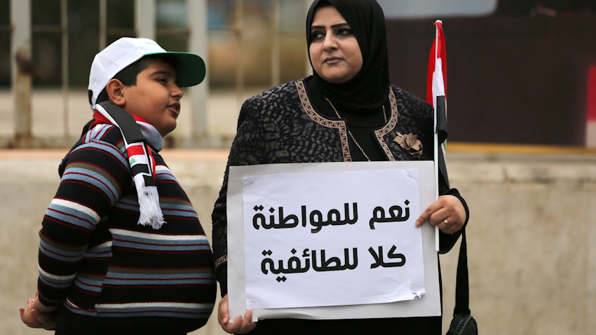 امرأة عراقية تحمل لافتة كتب عليها "نعم للمواطنة لا للطائفية" خلال مظاهرة ضد الفساد في بغداد. 22 يناير/كانون الثاني 2016 (الصورة عبر غيتي إيماجز)