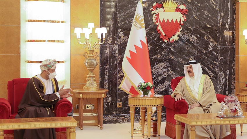 Omani Foreign Minister Sayyid Badr Al-Busaidi (L) meets with Bahrain's King Hamad bin Isa Al Khalifa in Manama on Aug. 29, 2021. (Handout photo via Twitter)