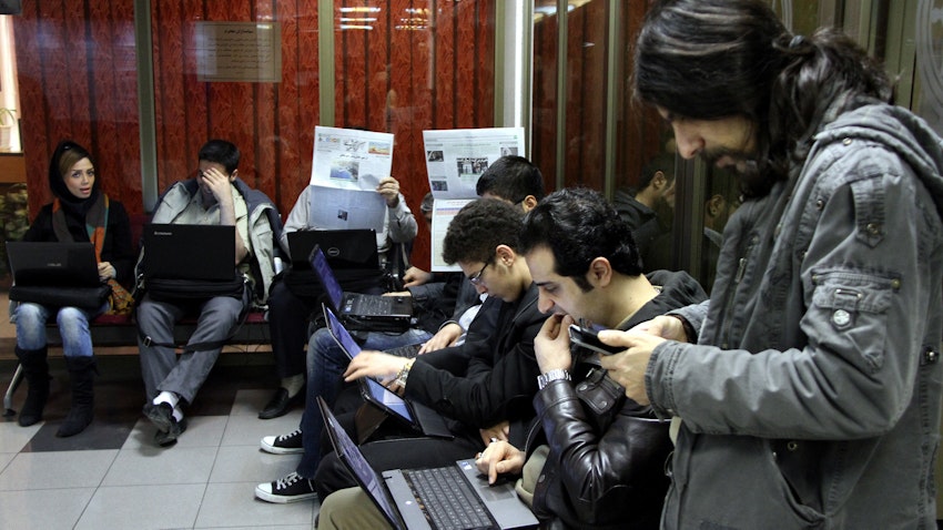 Iranian investors watch the prices of shares at the Tehran Stock Exchange on Jan. 4, 2014. (Photo via Getty Images)