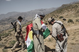 Kurdish Democratic Party of Iran (KDPI) fighters raise the flag of Kurdistan at their base in the Zagros mountains in the Iraq-Iran border on July 27, 2017. (Photo via Getty Images)