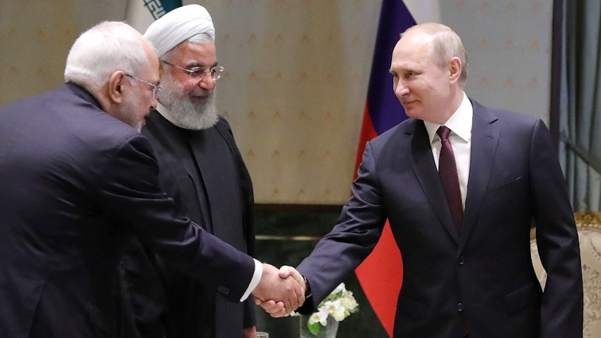 Iran's then Foreign Minister Mohammad Javad Zarif, then President Hassan Rouhani and Russia's President Vladimir Putin (L-R) meet in Ankara, Turkey on Aug. 4, 2018 (Photo via Getty Images)