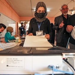 A woman voter casts her vote at a polling station in Iraq's capital Baghdad on Oct. 10, 2021. (Photo via Getty Images)