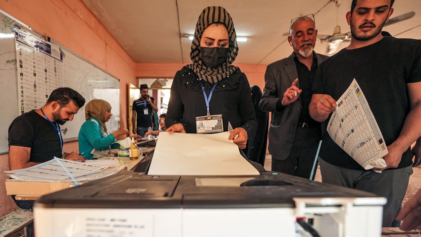 A woman voter casts her vote at a polling station in Iraq's capital Baghdad on Oct. 10, 2021. (Photo via Getty Images)