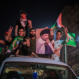 Supporters of Iraqi Shiite cleric Muqtada Al-Sadr celebrate their victory in the parliamentary elections in Baghdad, Iraq on Oct. 11, 2021. (Photo via Getty Images)