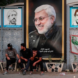 Supporters of the Popular Mobilization Units (PMU) rest outside the Green Zone in Baghdad, Iraq on Oct. 20, 2021. (Photo via Getty Images)