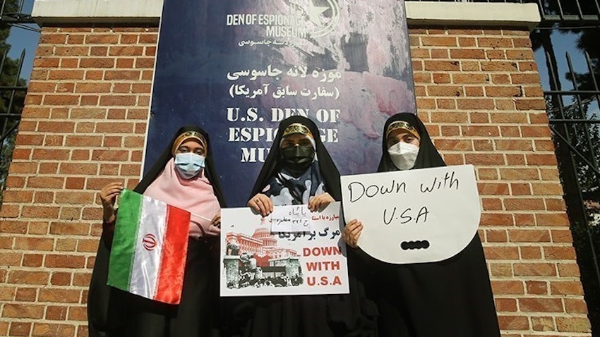 Iranian women hold anti-US banners while standing in front of the former US embassy in Tehran on Nov. 4, 2021. (Photo by Hossein Zohrevand via Tasnim News Agency)