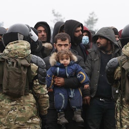 Migrants gather to receive humanitarian aid on the Belarusian-Polish border in the region of Grodno, Belarus on Nov. 14, 2021. (Photo via Getty Images)