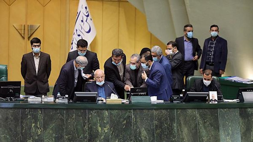 Iranian lawmakers surround the podium during a parliamentary session in Tehran on Nov. 7, 2021. (Photo via ICANA news agency)