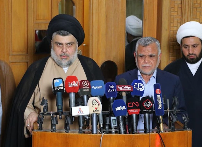 Sadrist Movement leader Muqtada Al-Sadr (L) and Fatah Alliance chief Hadi Al-Ameri (R) in Najaf, Iraq on Jun. 12, 2018. (Photo via Getty Images)
