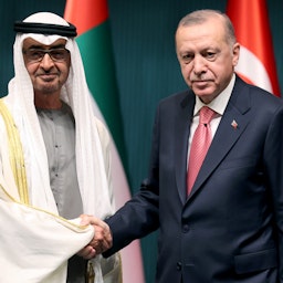 Turkish President Recep Tayyip Erdogan (R) shakes hands with Abu Dhabi's Crown Prince Sheikh Mohammed bin Zayed Al Nahyan in Ankara, on Nov. 24, 2021. (Photo via Getty Images)