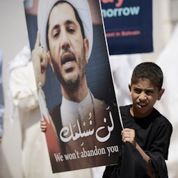 A young Bahraini protester holds a placard portraying Sheikh Ali Salman, head of the Shiite opposition movement Al-Wefaq, in Diraz, west of Manama on Apr. 3, 2015. (Mohammed Al-Shaikh/AFP via Getty Images)