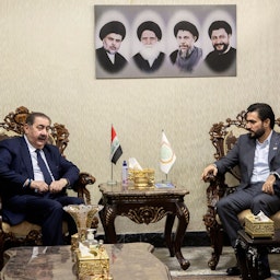Iraq's Sadrist bloc MP Hassan Al-Adari (R) meets with senior KDP official Hoshyar Zebari (L) to discuss the formation of the new government in the capital Baghdad, on Nov. 5, 2021. (Photo via Getty Images)