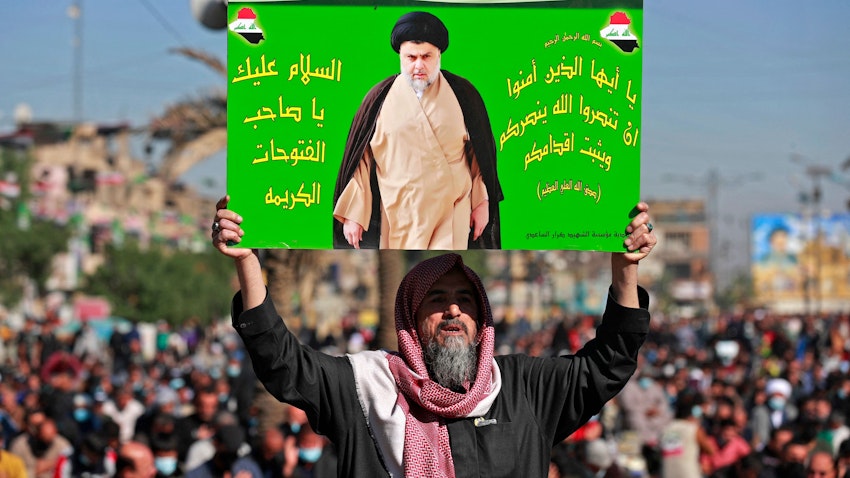 رجل عراقي يحمل صورة رجل الدين الشيعي مقتدى الصدر خلال صلاة الجمعة في بغداد. 3 ديسمبر/كانون الأول 2021 (الصورة عبر غيتي إيماجز)