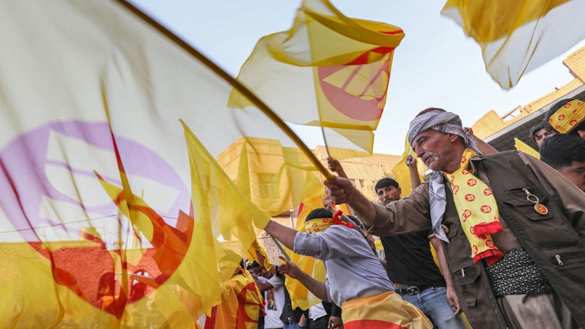Iraqi Kurds wave KDP flags during an election rally in Erbil, northern Iraq, on Oct. 7, 2021. (Photo via Getty Images)
