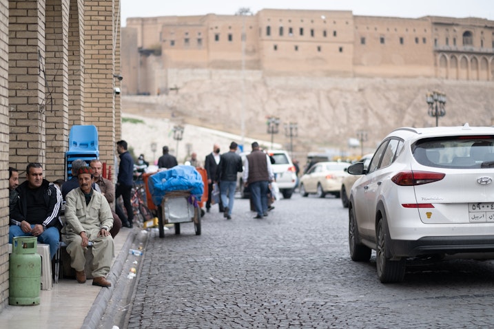 Men drinking tea by the citadel of Erbil, Iraq on Dec. 15, 2020. (Photo via Wikimedia)