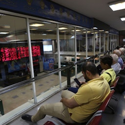 Iranian men at Tehran Stock Exchange, on July 1, 2019. (Photo by Atta Kenare via Getty Images)